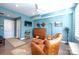 Living room with leather chairs, a wood cabinet, and blue walls at 824 Broad River Ln, Charlotte, NC 28211