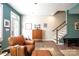 Living room features hardwood floors, a leather chair, and a staircase at 824 Broad River Ln, Charlotte, NC 28211