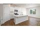 White kitchen with an island and hardwood floors at 862 Two Brothers Ln, York, SC 29745