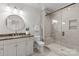 Modern bathroom with a frameless glass shower and dark vanity at 8904 Clavemorr Glenn Ct, Charlotte, NC 28226