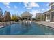 Resort-style pool with a pergola and plenty of seating at 8904 Clavemorr Glenn Ct, Charlotte, NC 28226