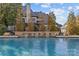 Luxury pool with stone waterfall feature and backyard view of home at 8904 Clavemorr Glenn Ct, Charlotte, NC 28226