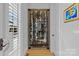 Impressive glass-front wine cellar with ample storage for bottles at 8904 Clavemorr Glenn Ct, Charlotte, NC 28226