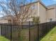 Private backyard with a black metal fence and small tree at 1010 Craven St, Indian Trail, NC 28079