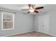 Bedroom featuring ceiling fan, window, and double doors at 1010 Craven St, Indian Trail, NC 28079