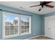 Bedroom with light blue walls, two windows, and ceiling fan at 1010 Craven St, Indian Trail, NC 28079