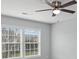 Bedroom with neutral walls, ceiling fan and two windows at 1010 Craven St, Indian Trail, NC 28079