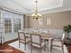 Virtually staged dining room featuring hardwood floors and a large table at 1010 Craven St, Indian Trail, NC 28079