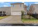 Two-car garage with a driveway and black metal fence at 1010 Craven St, Indian Trail, NC 28079