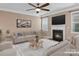 Virtually staged living room with fireplace and neutral-toned furniture at 1010 Craven St, Indian Trail, NC 28079
