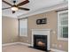 Living room with a fireplace, ceiling fan, and neutral decor at 1010 Craven St, Indian Trail, NC 28079