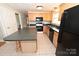 Modern kitchen featuring an island, wood cabinets, and black appliances at 1051 17Th Nw Ave, Hickory, NC 28601