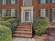 Brick front steps leading to a glass front door at 1201 Over Stream Ln, Matthews, NC 28105