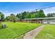 Brick building with green metal roof and spacious yard at 1318 Ostwalt Amity Rd, Cleveland, NC 27013