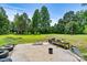 Large grassy yard with various items and trees at 1318 Ostwalt Amity Rd, Cleveland, NC 27013