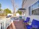 Small deck with two blue chairs overlooking backyard at 141 Linwood Dr, Albemarle, NC 28001