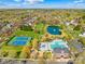 Beautiful community aerial view showcasing the pool, tennis courts, pond, and well-manicured landscaping at 14500 Harvington Dr, Huntersville, NC 28078