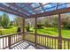 A beautiful backyard featuring lush green grass and a cozy pergola-covered deck at 14500 Harvington Dr, Huntersville, NC 28078