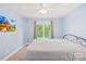 Bedroom featuring a fan, mounted TV, and neutral carpet and paint at 14500 Harvington Dr, Huntersville, NC 28078