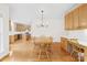 Open concept dining area with hardwood floors that connects to kitchen and adjacent rooms at 14500 Harvington Dr, Huntersville, NC 28078