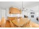 Light-filled dining area with stylish chandelier, wood table, and a convenient built-in serving area at 14500 Harvington Dr, Huntersville, NC 28078
