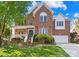 Charming two-story brick home boasts a well-manicured lawn and inviting front porch perfect for relaxing at 14500 Harvington Dr, Huntersville, NC 28078