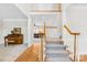 Elegant foyer with carpeted living room and staircase with wood and white railings at 14500 Harvington Dr, Huntersville, NC 28078
