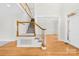 Bright foyer featuring hardwood floors, staircase with white spindles, and view to an adjacent living space at 14500 Harvington Dr, Huntersville, NC 28078