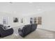 Spacious living room featuring neutral carpet and paint, large windows, and recessed lighting at 14500 Harvington Dr, Huntersville, NC 28078