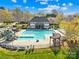Aerial view of the pool with a playground, pergola, clubhouse, and plenty of space to enjoy at 14500 Harvington Dr, Huntersville, NC 28078