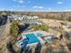 Enjoy this aerial view featuring the community pool, clubhouse, and tennis courts at 16812 Lookout Landing Ln, Charlotte, NC 28278