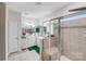 Bathroom with tiled shower, double vanity with mirrors, and neutral color palette at 16812 Lookout Landing Ln, Charlotte, NC 28278