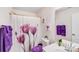 Charming bathroom with a shower featuring a floral curtain, purple accents and a bright vanity at 16812 Lookout Landing Ln, Charlotte, NC 28278