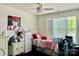 Bright bedroom featuring a ceiling fan, large window, and tastefully chosen decor at 16812 Lookout Landing Ln, Charlotte, NC 28278