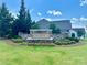 Neighborhood sign with a stone base, fountain, professional landscaping, and well-maintained lawn at 16812 Lookout Landing Ln, Charlotte, NC 28278