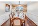 Elegant dining room with stone accent wall, hardwood floors, and wainscoting at 16812 Lookout Landing Ln, Charlotte, NC 28278