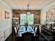 Elegant dining room featuring a stone accent wall, sophisticated furnishings, and a modern chandelier at 16812 Lookout Landing Ln, Charlotte, NC 28278