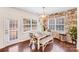 Bright dining area with natural light, stone accent wall, and hardwood floors at 16812 Lookout Landing Ln, Charlotte, NC 28278