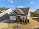 Charming two-story home with a well-manicured lawn and an attached two-car garage at 16812 Lookout Landing Ln, Charlotte, NC 28278