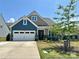 Charming two-story home featuring a spacious garage, beautiful landscaping and Craftsman-style architecture at 16812 Lookout Landing Ln, Charlotte, NC 28278