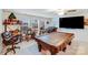 Inviting game room featuring a pool table, bar area, and large flat-screen TV, perfect for entertaining guests at 16812 Lookout Landing Ln, Charlotte, NC 28278