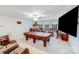 Spacious game room with a pool table, comfortable seating, and a large TV for ultimate relaxation at 16812 Lookout Landing Ln, Charlotte, NC 28278