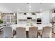 Spacious kitchen featuring a large island, white cabinetry, and stone accent wall at 16812 Lookout Landing Ln, Charlotte, NC 28278