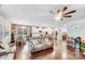 Open concept living space with hardwood floors, modern furniture, and stone accent wall at 16812 Lookout Landing Ln, Charlotte, NC 28278
