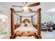 A spacious bedroom with a decorative four-poster bed and ceiling fan at 16812 Lookout Landing Ln, Charlotte, NC 28278