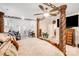 Bedroom with a four-poster bed, ceiling fan, and access to a balcony at 16812 Lookout Landing Ln, Charlotte, NC 28278