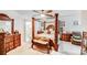 An elegant bedroom featuring a four-poster bed, a ceiling fan, and natural light at 16812 Lookout Landing Ln, Charlotte, NC 28278