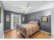 Bedroom featuring neutral walls, wood floor, double doors to a balcony, and colorful quilt at 1703 Fairway Dr, Newton, NC 28658