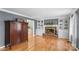 Living room showcasing a brick fireplace, built-in shelving, hardwood floors, and neutral paint at 1703 Fairway Dr, Newton, NC 28658