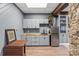 Basement wet bar area, featuring wood countertops, stainless steel refrigerator, and gray cabinetry at 1703 Fairway Dr, Newton, NC 28658